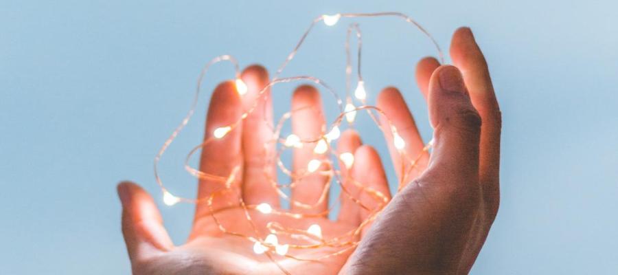 Hands holding fairy lights