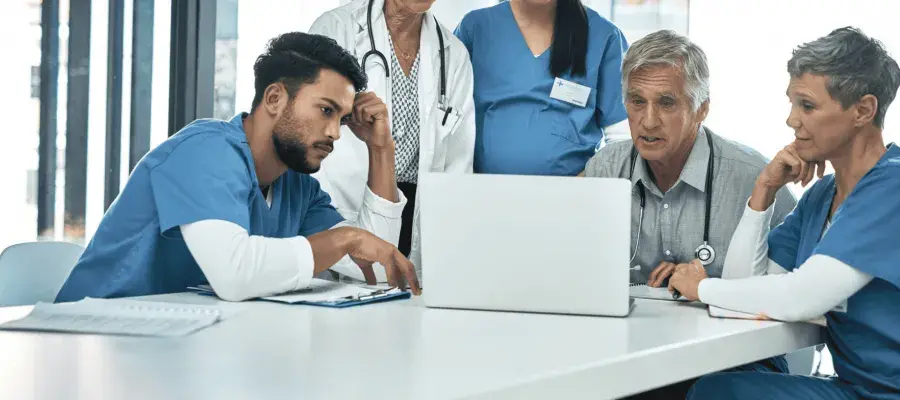 Group of researchers and nurses sitting around the table