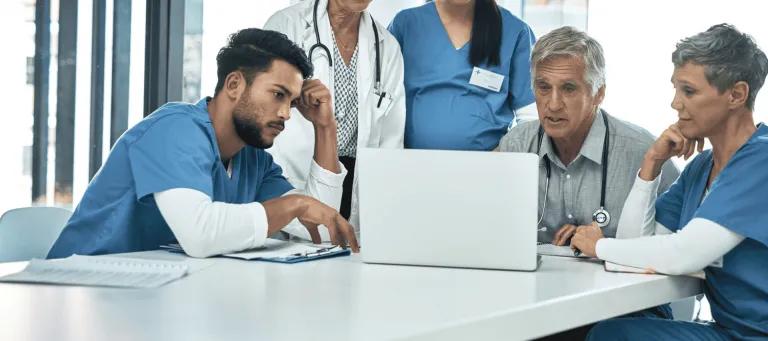 Group of researchers and nurses sitting around the table