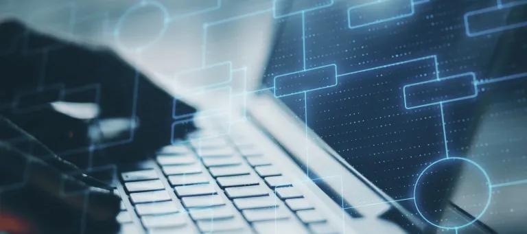 Abstract image of person typing on laptop