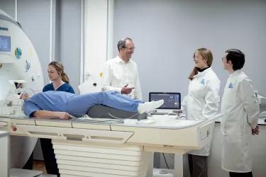 MRI scanner with patient and researchers
