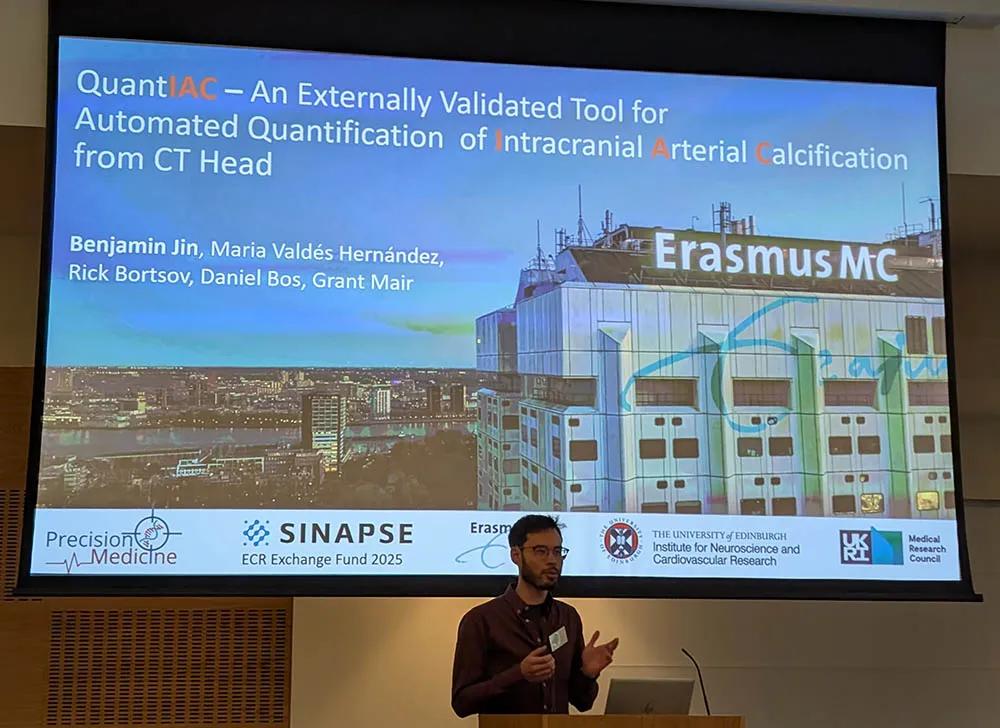 Benjamin Jin in front of his powerpoint presentation at the SINAPSE annual scientific meeting