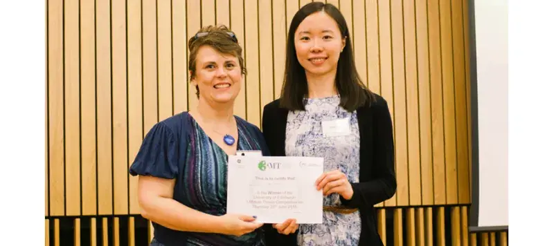 Chen Zhao is presented with her winning Three Minute Thesis certificate