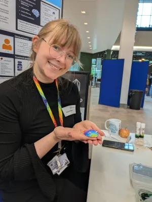 Researcher with small decorated plaster brain